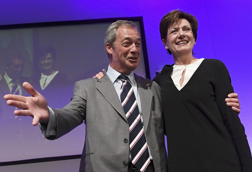 Nigel Farage (L), the outgoing leader of the United Kingdom Independence Party (UKIP), congratulates new leader Diane James, at the party&#039;s annual conference in Bournemouth, Britain, September 16 ...