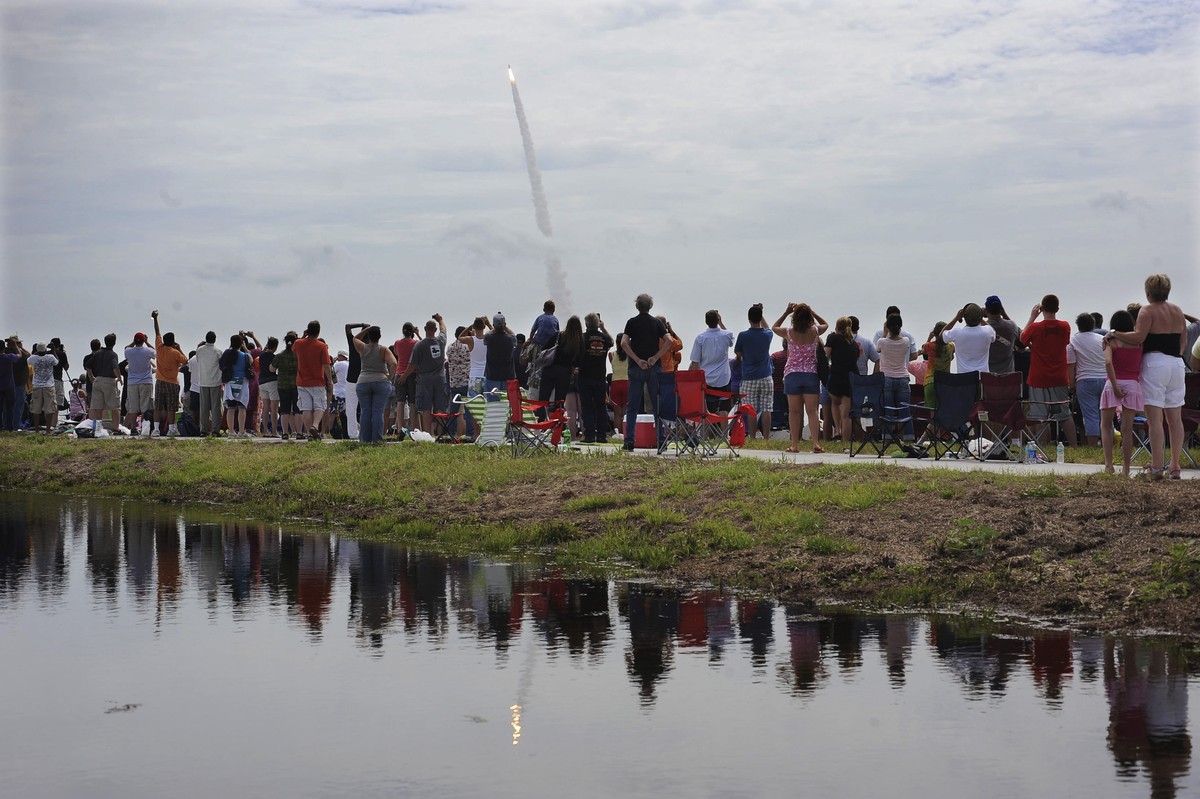 FILE - In this July 8, 2011 file photo, spectators watch the space shuttle Atlantis lift off from the Kennedy Space Center at Cape Canaveral, Fla. Atlantis was the 135th and final space shuttle launch ...