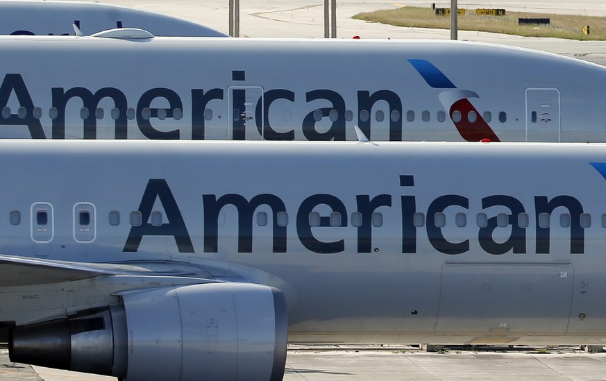 FILE - In this Monday, Nov. 6, 2017, file photo, a pair of American Airlines jets are parked on the airport apron at Miami International Airport in Miami. A scheduling glitch has left American scrambl ...