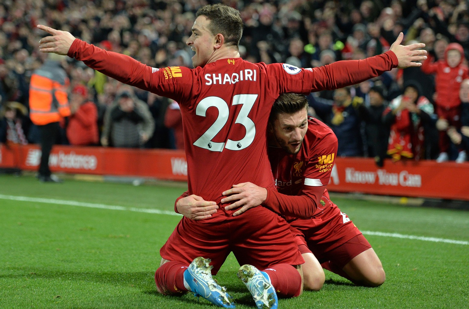 epa08044994 Xherdan Shaqiri (L) of Liverpool celebrates with teammate Adam Lallana after scoring the 2-0 during the English Premier League soccer match between Liverpool FC and Everton in Liverpool, B ...