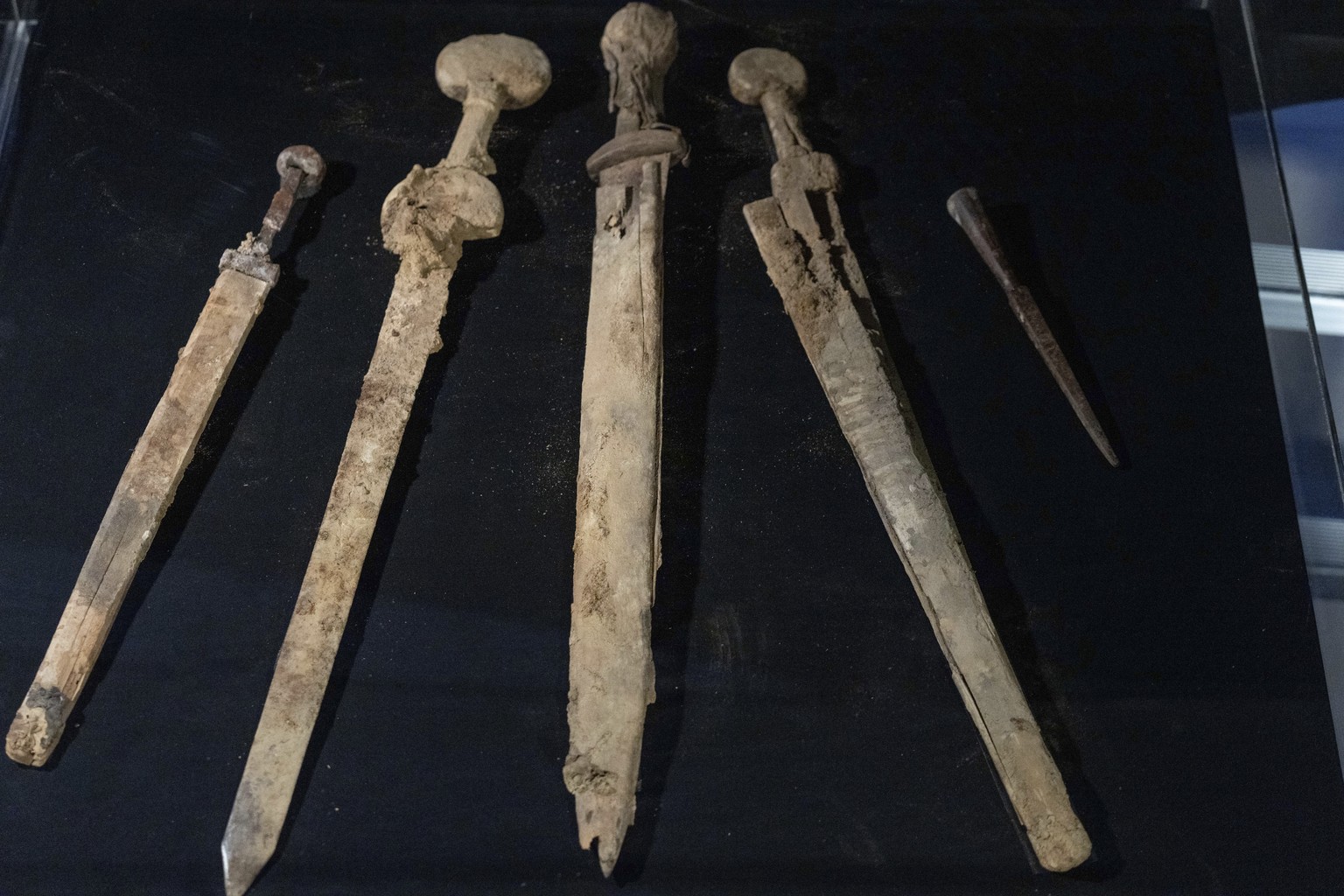 Israeli archaeologists show four Roman-era swords and a javelin head found during a recent excavation in a cave near the Dead Sea, in Jerusalem, Wednesday, Sep. 6, 2023. Archaeologists said the except ...