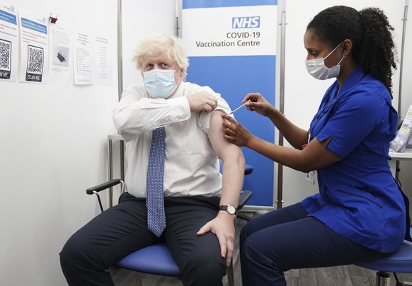 FILE - Britain's Prime Minister Boris Johnson receives his booster shot of the coronavirus vaccine at St Thomas Hospital in London, Thursday, Dec. 2, 2021. On Friday, Dec. 10, The Associated Press rep ...