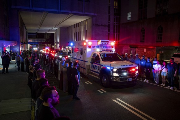 The ambulance carrying the body of Didarul Islam exits NewYork-Presbyterian/Weill Cornell Medical Hospital during the dignified transfer of the slain officer, who was shot and killed by a gunman Monda ...