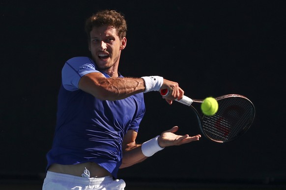 Pablo Carreno Busta of Spain plays a forehand return to Sebastian Korda of the U.S. during their third round match at the Australian Open tennis championships in Melbourne, Australia, Friday, Jan. 21, ...