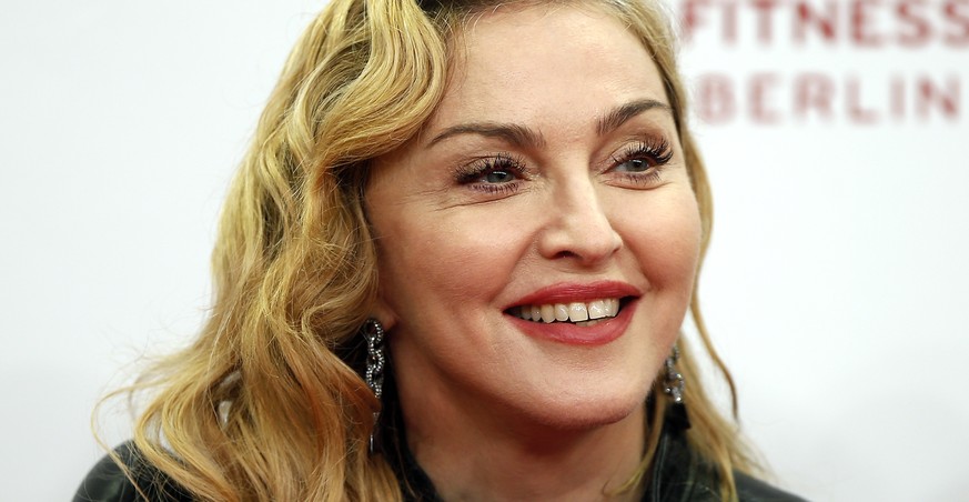 FILE - In this Oct. 17, 2013, file photo, U.S. pop star Madonna smiles during her visit at the &quot;Hard Candy Fitness&quot; center in Berlin. Madonna attended a preview of &quot;Holler If Ya Hear Me ...