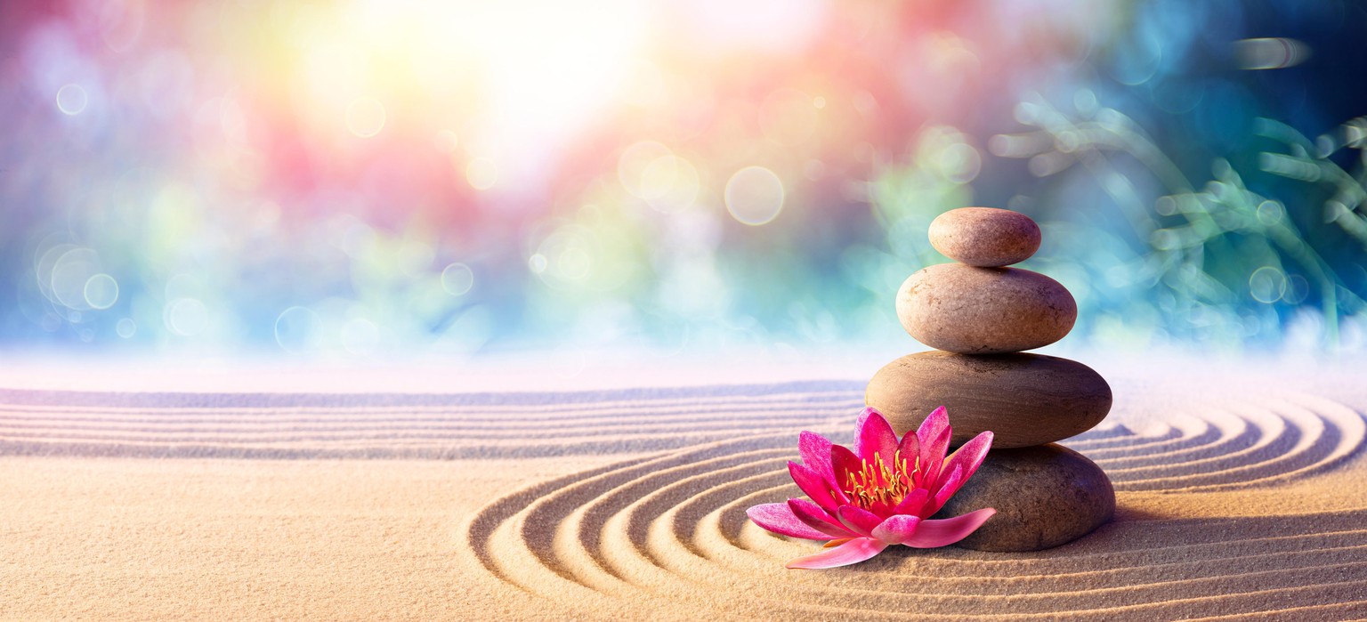 Das bildliche Einmaleins der Wellness-Welt: Lotusblüte, Steinmännchen, Zen-Sand.