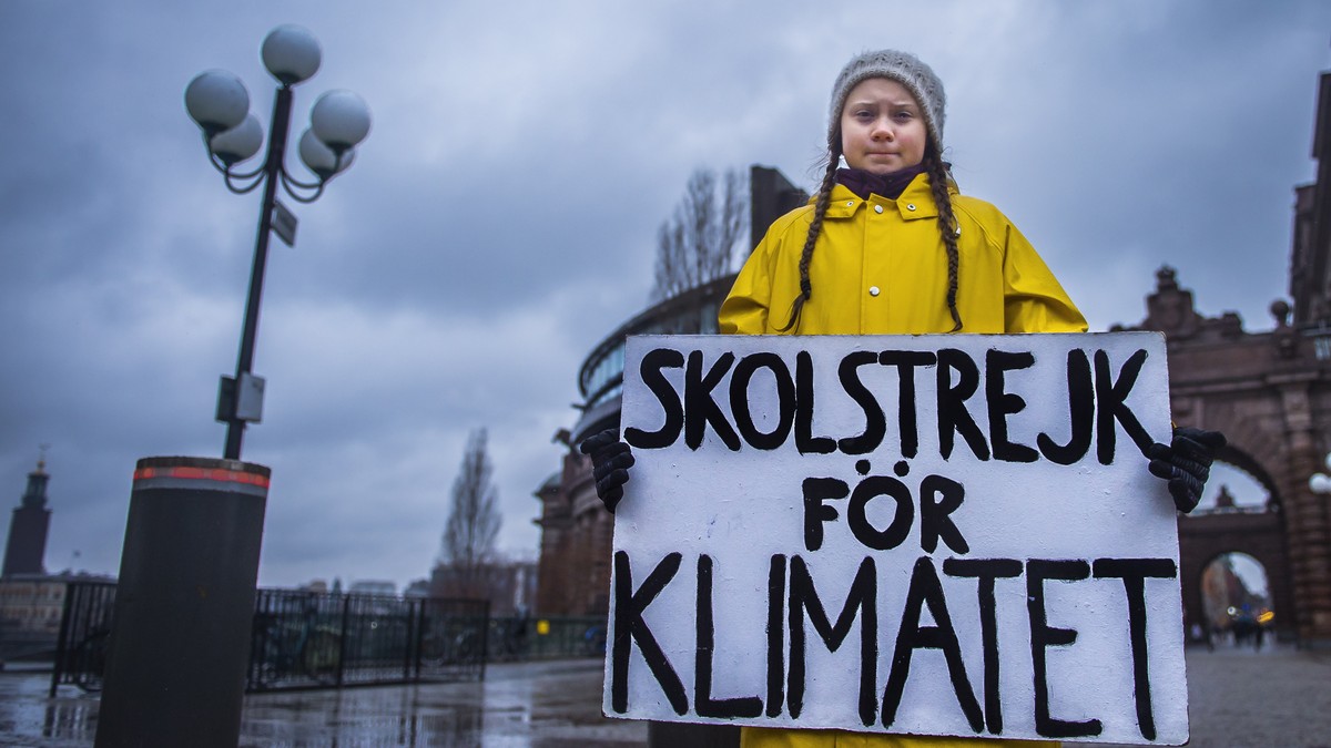 epaselect epa07199174 Swedish 15-year-old girl Greta Thunberg holds a placard reading 'School strike for the climate', during a protest against climate change outside the Swedish parliament  ...