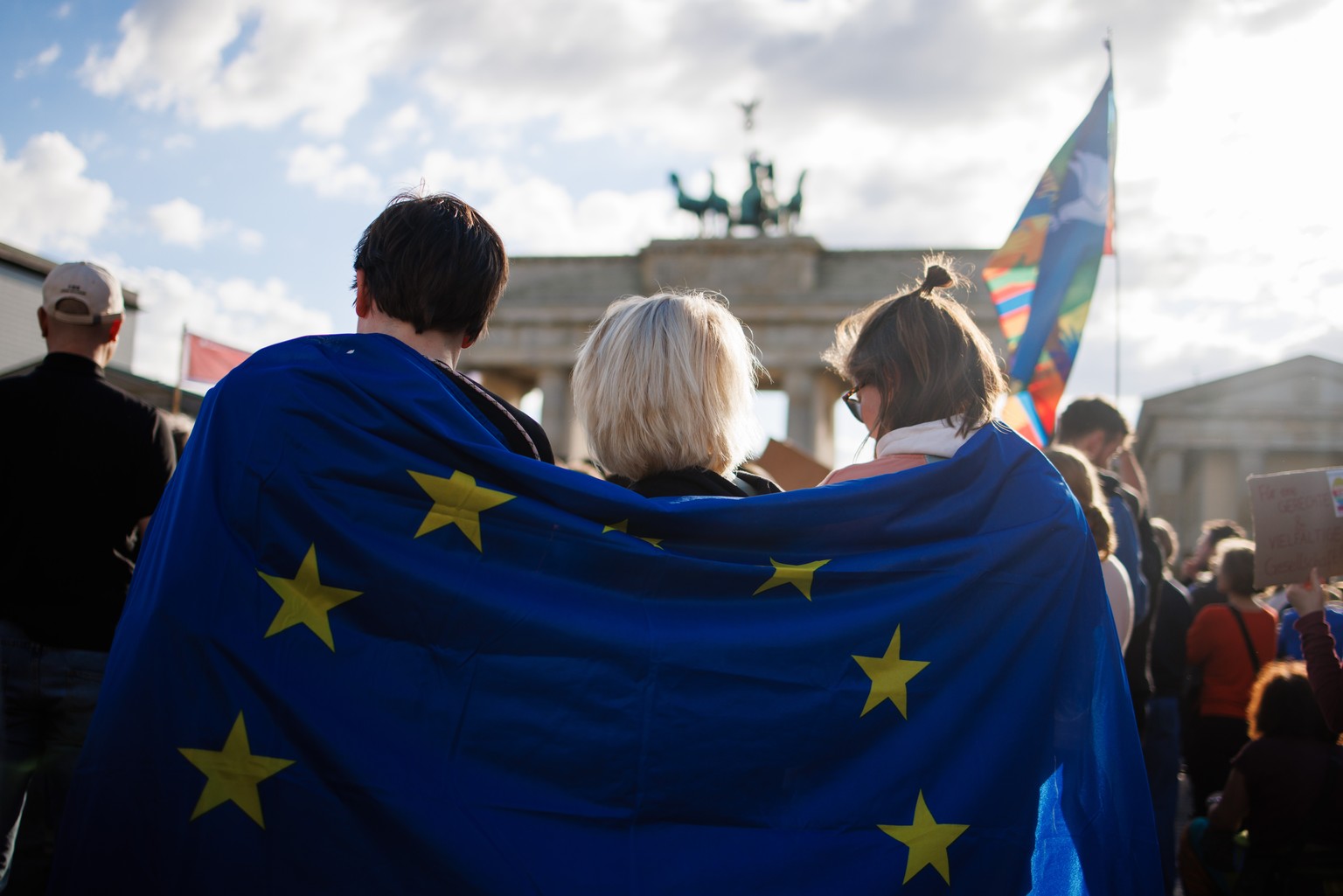 epa11320465 Participants hold a European Union flag, wrapped around their shoulders, during a rally in reaction to attacks on campaigning politicians in Germany, in Berlin, Germany, 05 May 2024. The r ...