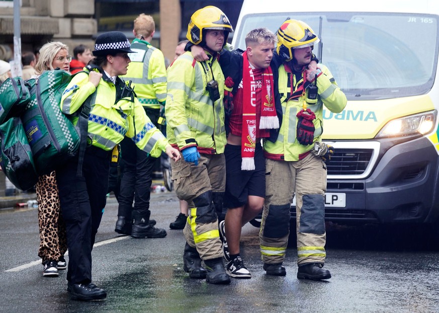 Police and emergency personnel deal with a road traffic accident on Water Street near the Liver Building in Liverpool after a car collided with pedestrians during the Premier League winners parade, in ...