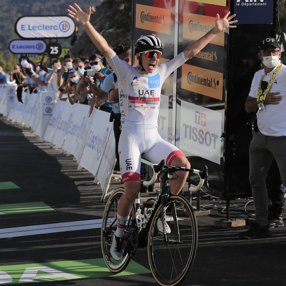 Slovenia&#039;s Tadej Pogacar, wearing the best young rider&#039;s white jersey, crosses the finish line ahead of Slovenia&#039;s Primoz Roglic, wearing the overall leader&#039;s yellow jersey, left,  ...