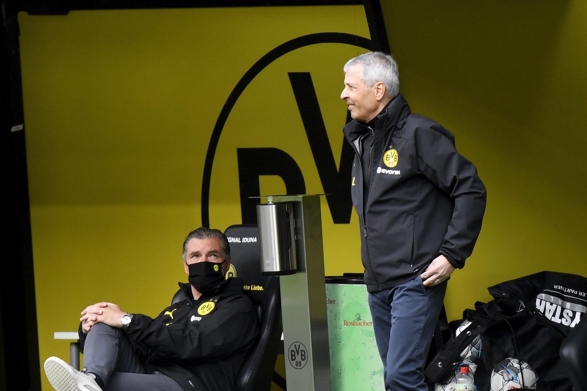 Dortmund's head coach Lucien Favre stands by the bench during the German Bundesliga soccer match between Borussia Dortmund and Schalke 04 in Dortmund, Germany, Saturday, May 16, 2020. The German  ...