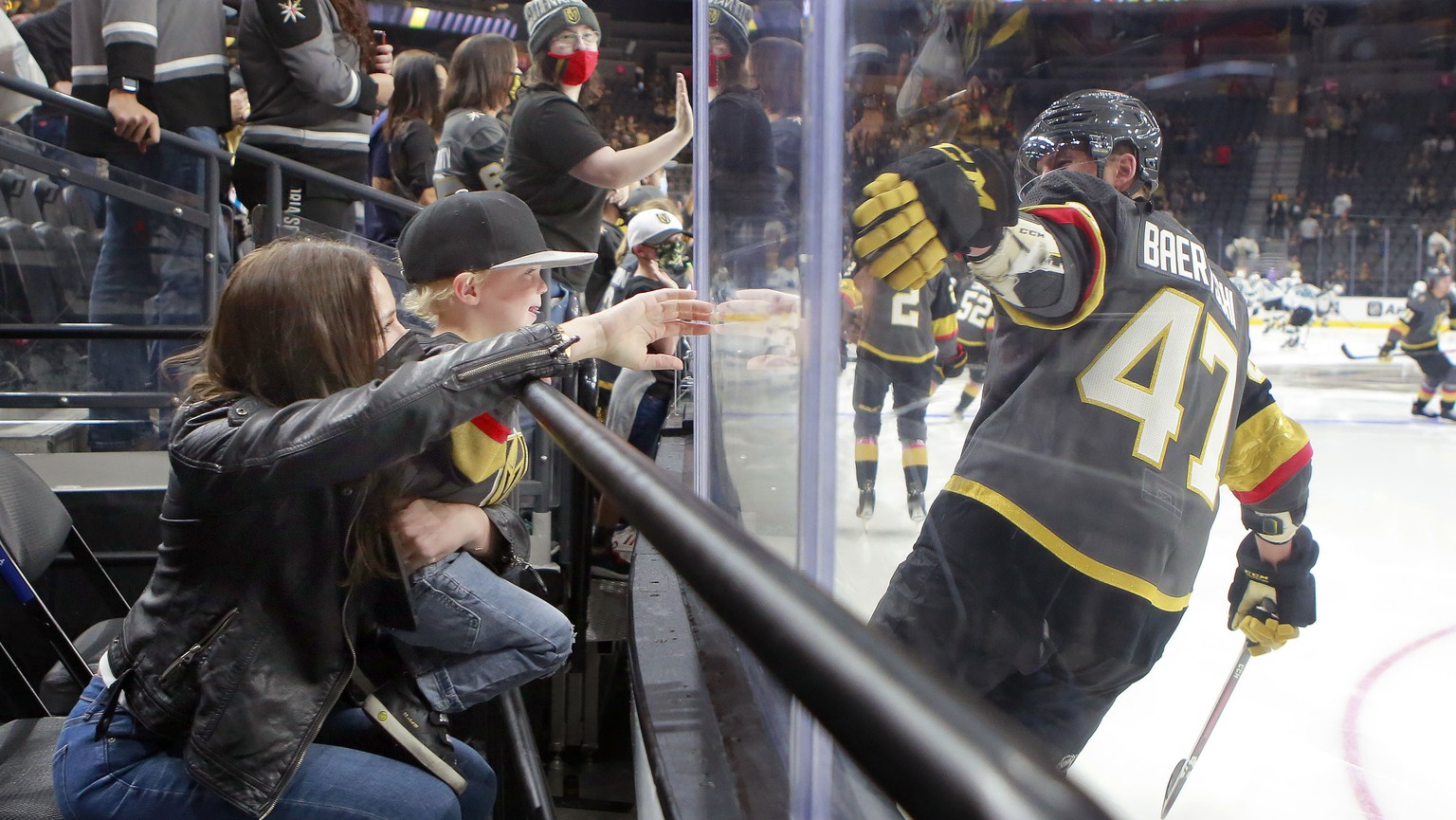 Vegas Golden Knights left wing Sven Baertschi (47) is greeted by his wife, Laura, and son Callan, 2, when taking the ice prior to the start of an NHL hockey preseason game against the San Jose Sharks, ...