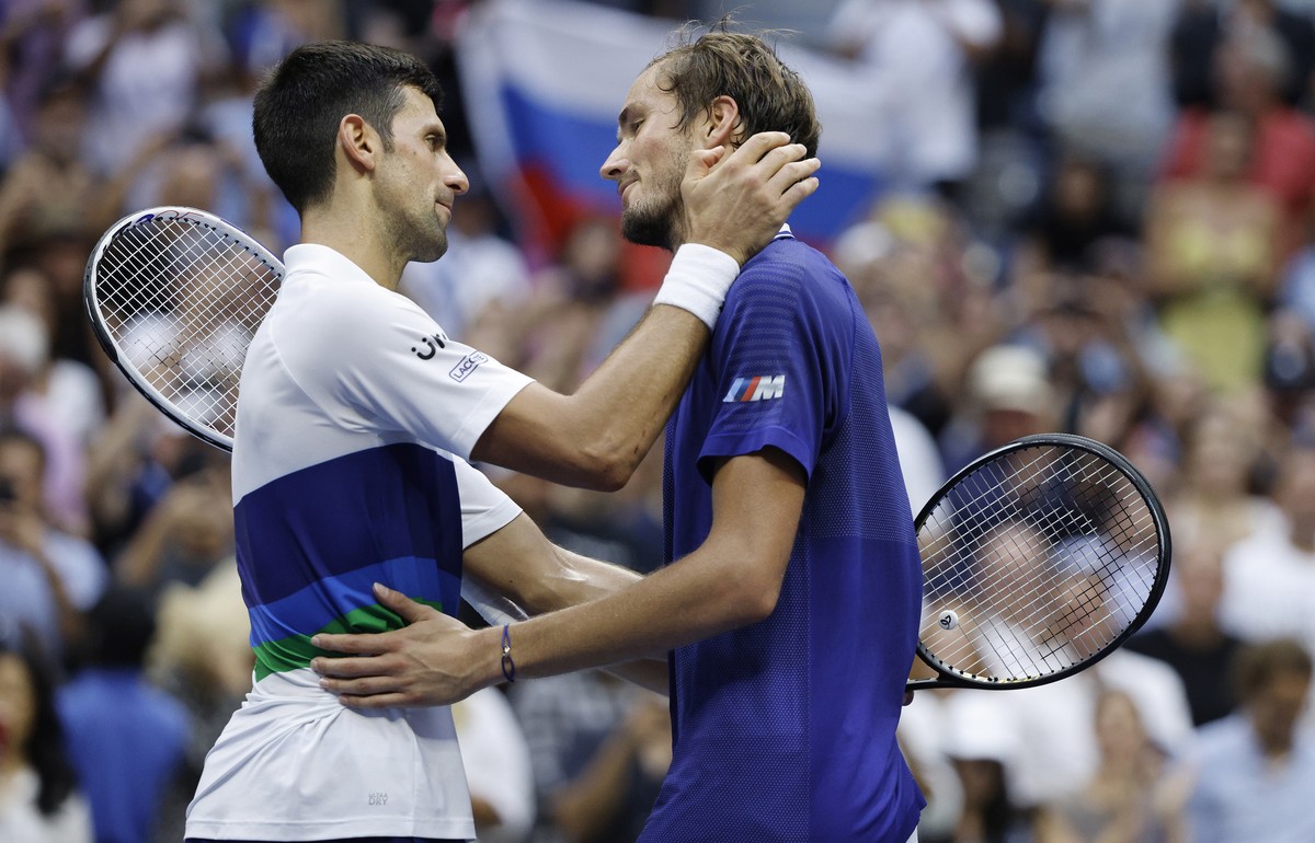 epa09464575 Daniil Medvedev of Russia (R) and Novak Djokovic of Serbia embrace at the net after their men's final match on the fourteenth day of the US Open Tennis Championships at the USTA Natio ...