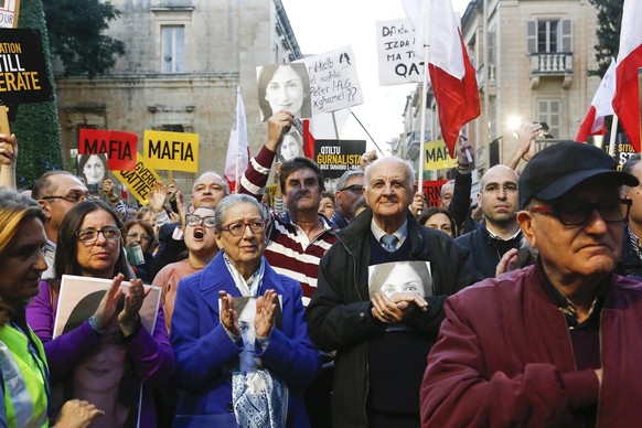 Rose Vella, center left, mother of late Daphne Caruana Galizia, and father of Daphne, Michael Vella, attend a protest in La Valletta, Malta, Sunday, Dec. 1, 2019. Malta&#039;s embattled prime minister ...