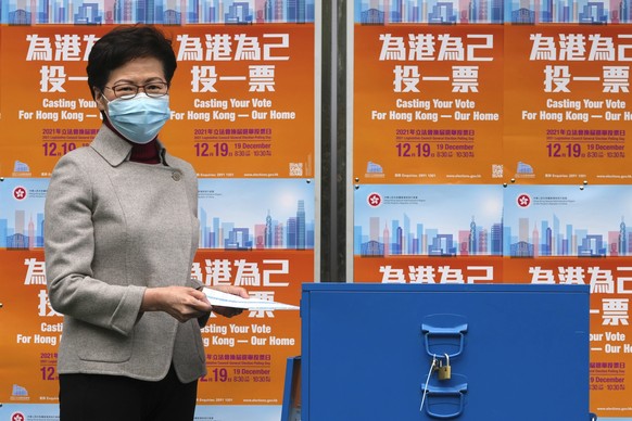 Hong Kong Chief Executive Carrie Lam poses as she casts her ballot at a polling station for the Legislative election in Hong Kong, Sunday, Dec. 19, 2021. Hong Kong was voting Sunday in the first elect ...