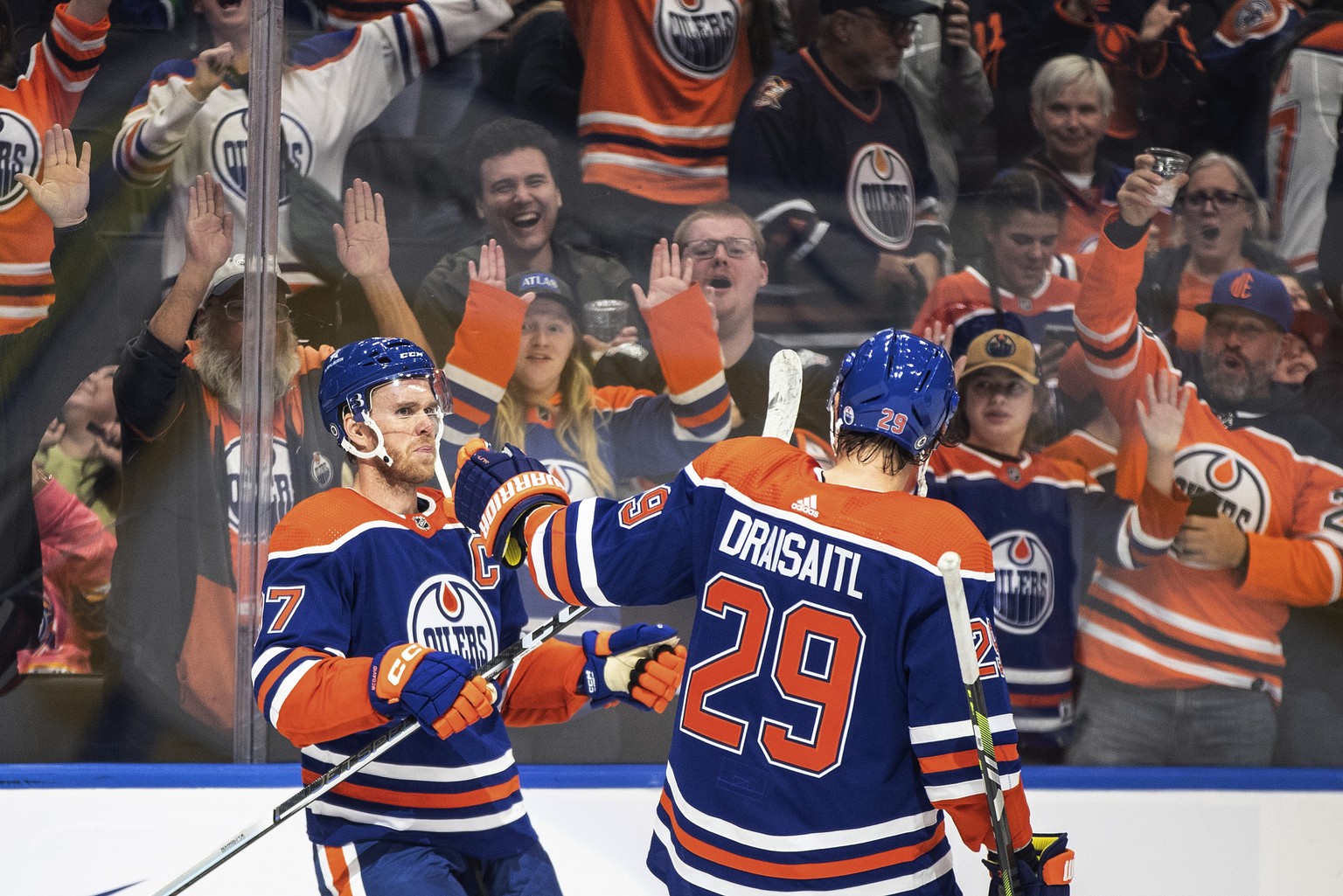 Edmonton Oilers&#039; Connor McDavid (97) and Leon Draisaitl (29) celebrate an overtime goal against the Vancouver Canucks in an NHL hockey preseason game Wednesday, Sept. 27, 2023, in Edmonton, Alber ...