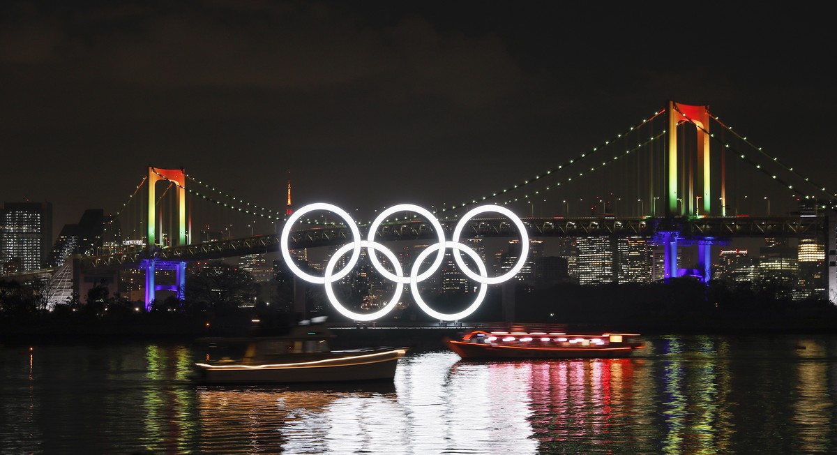 epa08331726 (FILE) - The Olympic Rings monument is illuminated at Odaiba Marine Park as the Rainbow Bridge is illuminated in rainbow colours to commemorate half a year before the opening of the Tokyo  ...