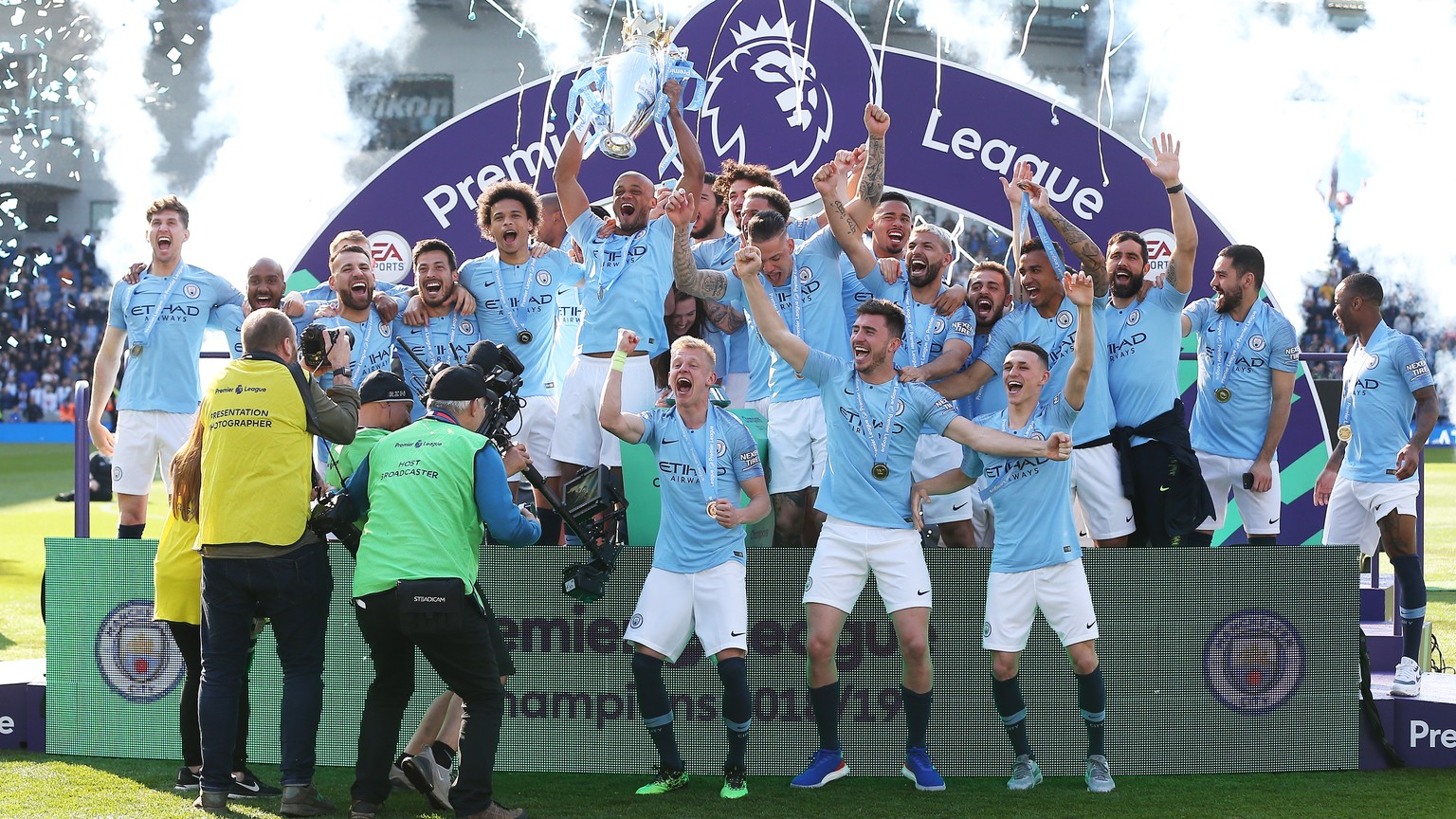 epa07565347 Manchester City captain Vincent Kompany lifts the trophy among teammates after the English Premier League match between Brighton and Hove Albion and Manchester City, Brighton, Britain, 12  ...