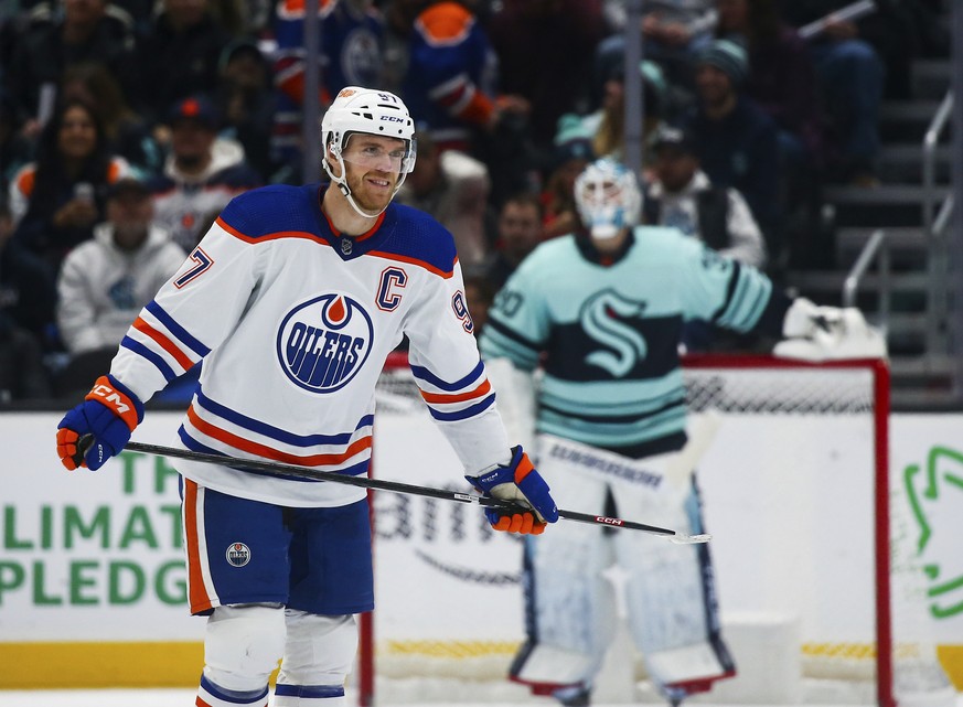 Edmonton Oilers center Connor McDavid (97) smiles after scoring a goal against the Seattle Kraken during the third period of an NHL hockey game Friday, Dec. 30, 2022, in Seattle. (AP Photo/Lindsey Was ...