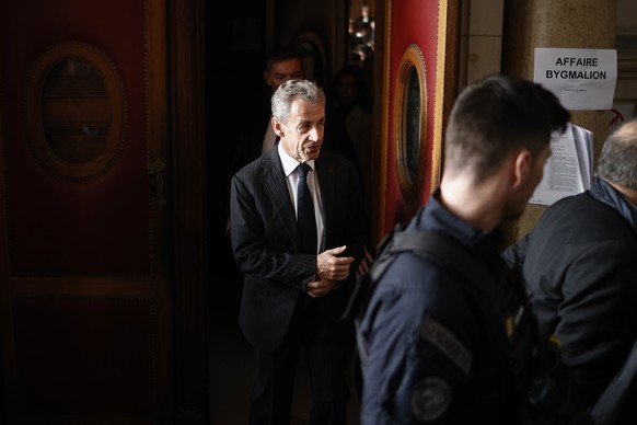 epa11152181 Former French president Nicolas Sarozy leaves the courthouse after being convicted to one year in prison with six months suspended by the Paris appeals court for exceeding the electoral sp ...