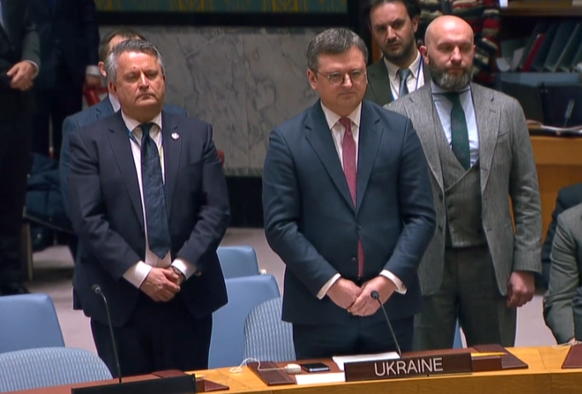 Dmytro Kuleba (with red tie) and his colleagues stand up.