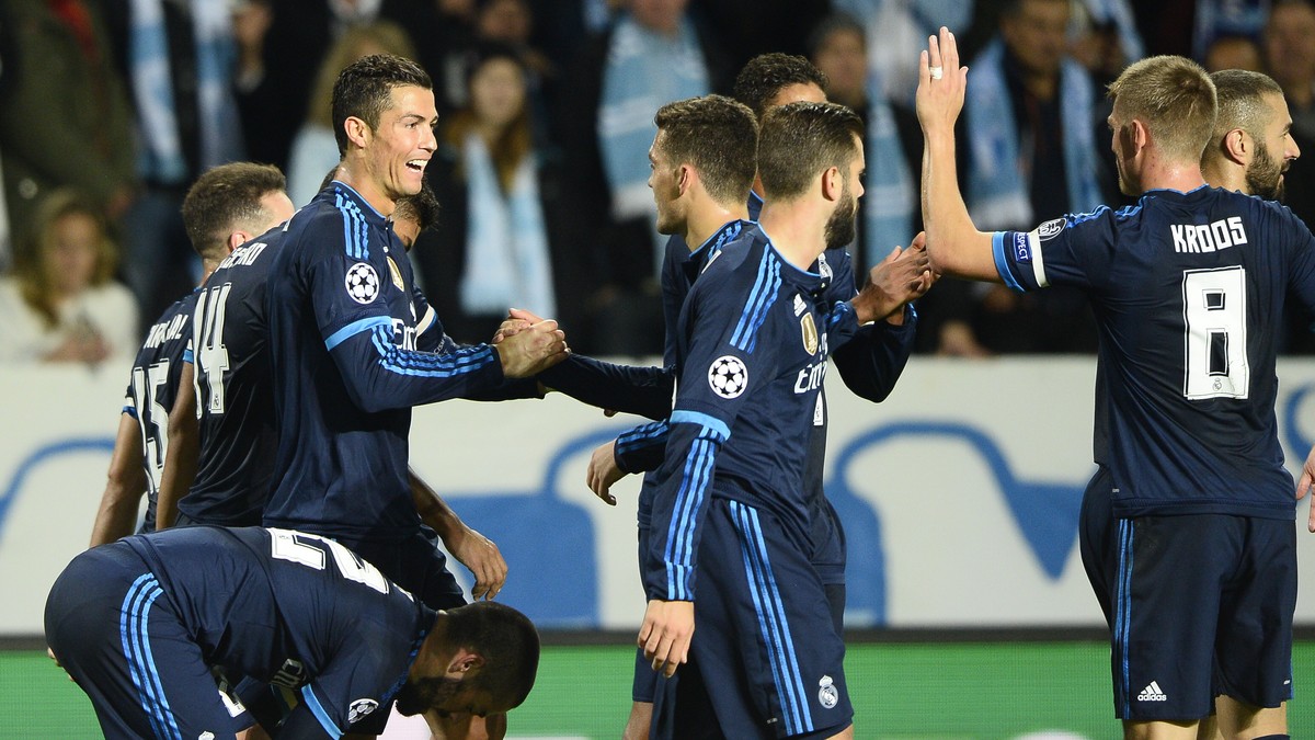 Real Madrid's Cristiano Ronaldo, left, celebrates with team mates after scoring the opening goal during the UEFA Champions League group A football match between Malmo FF and Real Madrid at Malmo  ...