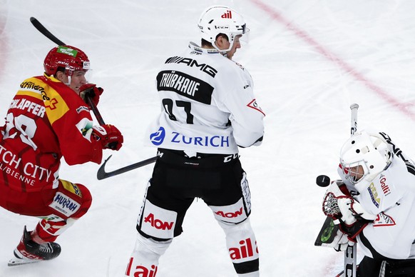 Biels Elvis Schlaepfer, Luganos Calvin Thuerkauf und Luganos Torhueter Leland Irving, von links, im Eishockey Meisterschaftsspiel der National League zwischen EHC Biel und HC Lugano, am Freitag, 29. O ...