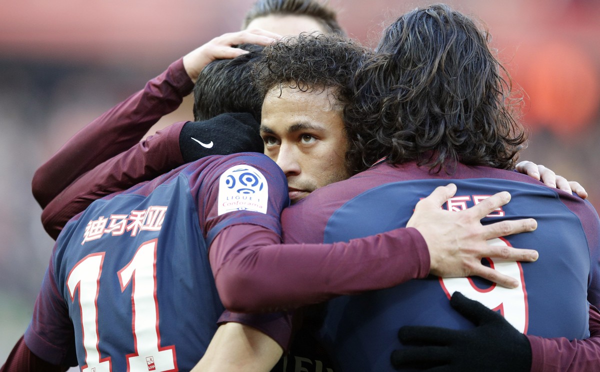 PSG's Neymar hugs teammates after Angel Di Maria scores a goal against Strasbourg during the French League One soccer match between Paris Saint Germain and Strasbourg, at the Parc des Princes sta ...