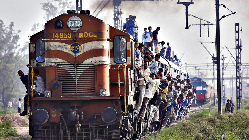 Passengers travel on an overcrowded train at Loni town in Uttar Pradesh...Passengers travel on an overcrowded train at Loni town in the northern Indian state of Uttar Pradesh July 8, 2014. On Tuesday, ...