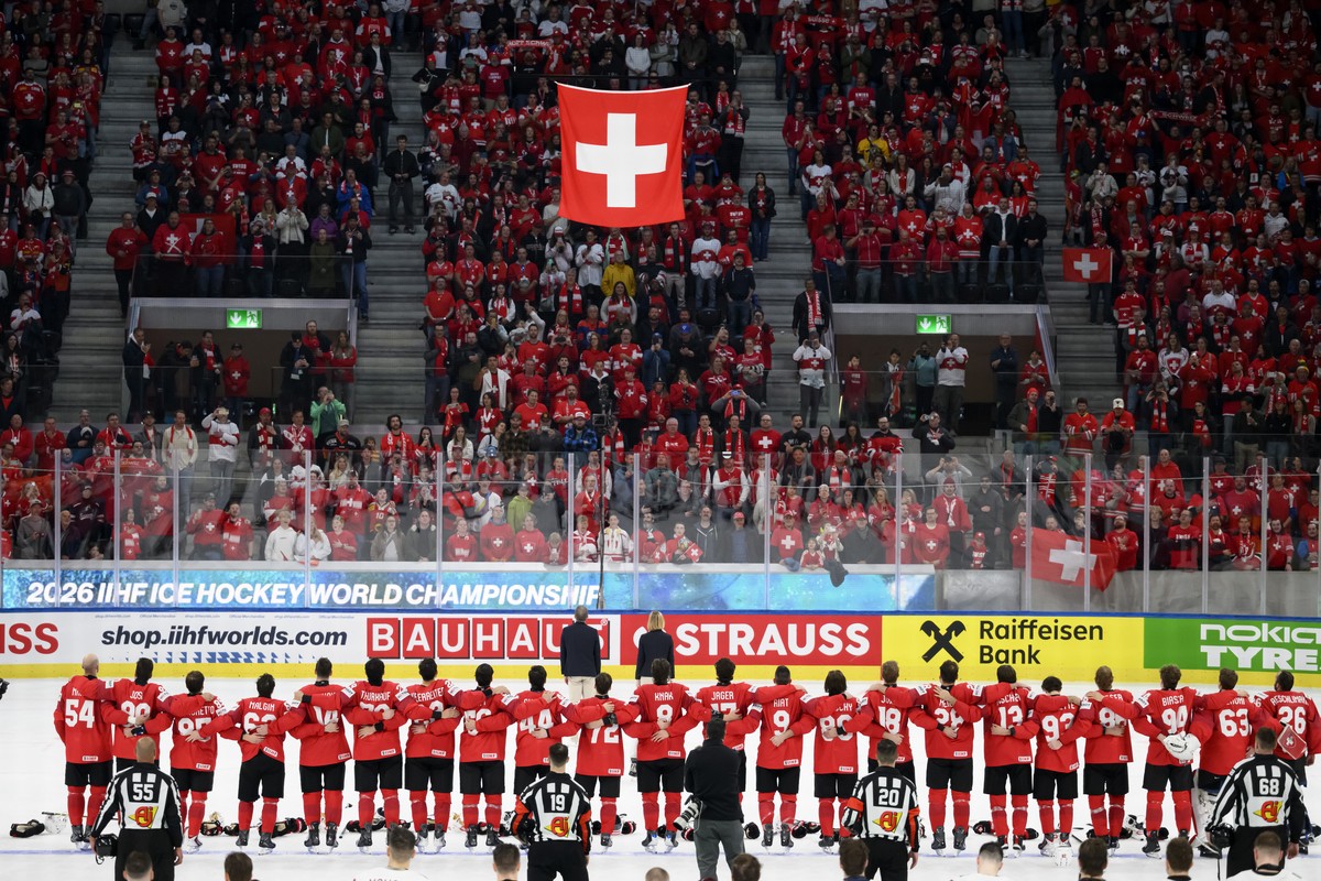 KEYPIX - Switzerland's players celebrate the victory under the Swiss flag after the 2026 IIHF Men's Ice Hockey World Championship preliminary round group A game between Switzerland and Latvi ...