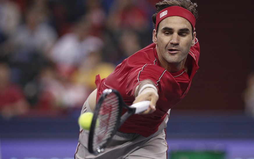 Roger Federer of Switzerland hits a return shot against Albert Ramos-Vinolas of Spain during their men&#039;s singles match at the Shanghai Masters tennis tournament at Qizhong Forest Sports City Tenn ...