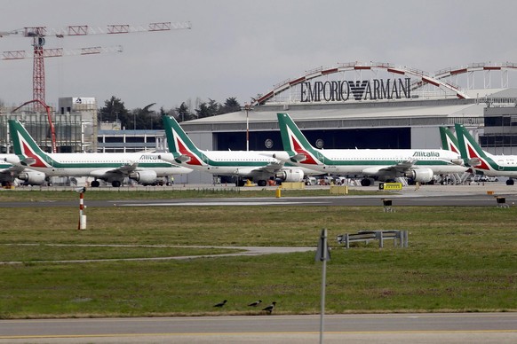 epa08291785 Aircraft of the Italian flag carrier Alitalia remain docked at the deserted Milan Linate Airport amid the coronavirus pandemic in Milan, northern Italy, 13 March 2020. The airport, Milan&# ...