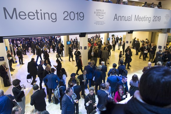 Participants walk inside the Congress Center during the 49th Annual Meeting of the World Economic Forum, WEF, in Davos, Switzerland, Wednesday, January 23, 2019. The meeting brings together entreprene ...