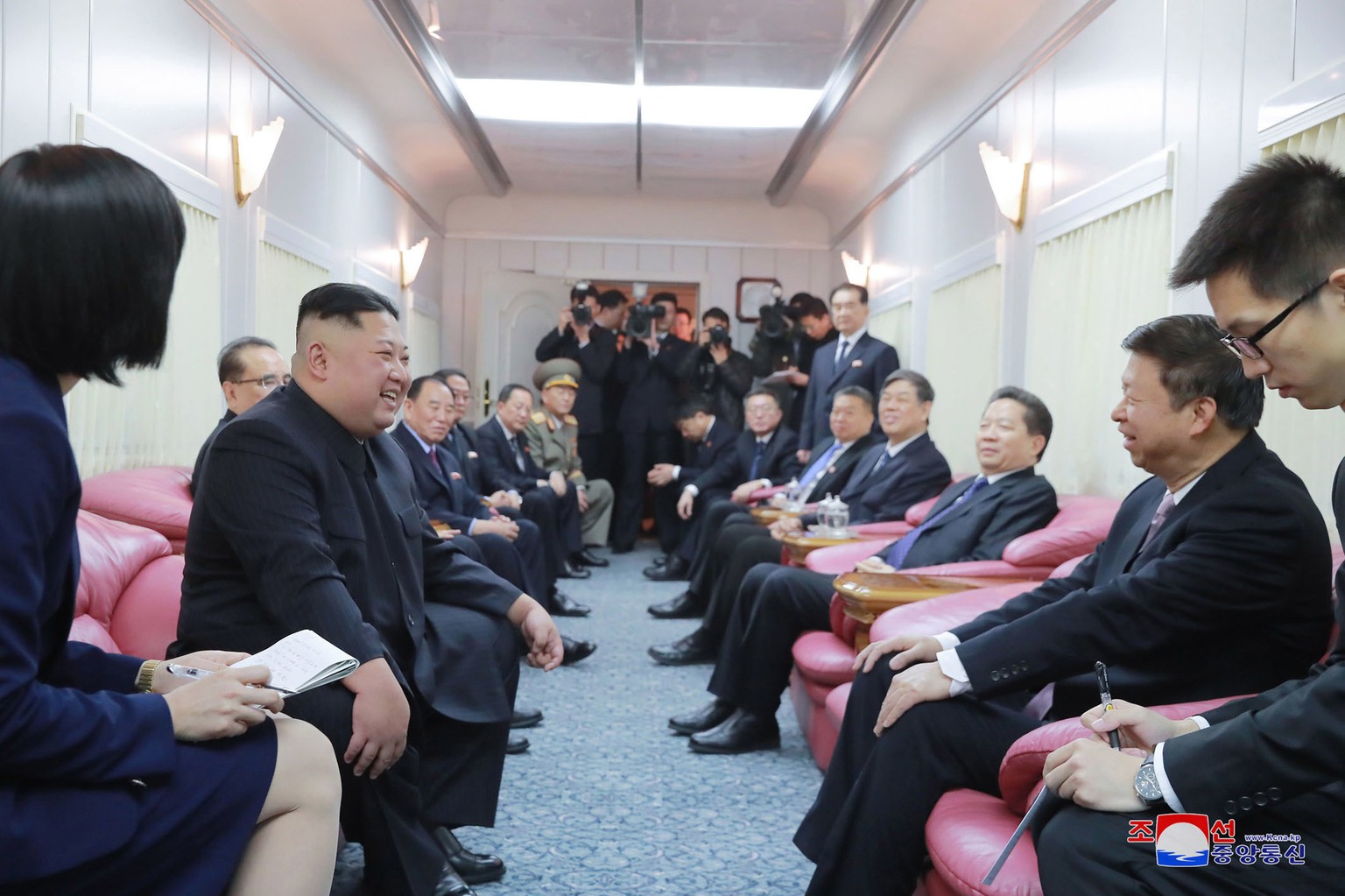 FILE - In this North Korean government photo, North Korean leader Kim Jong Un, second from left, talks with Song Tao, the head of the Chinese Communist Party's international department, second from right...