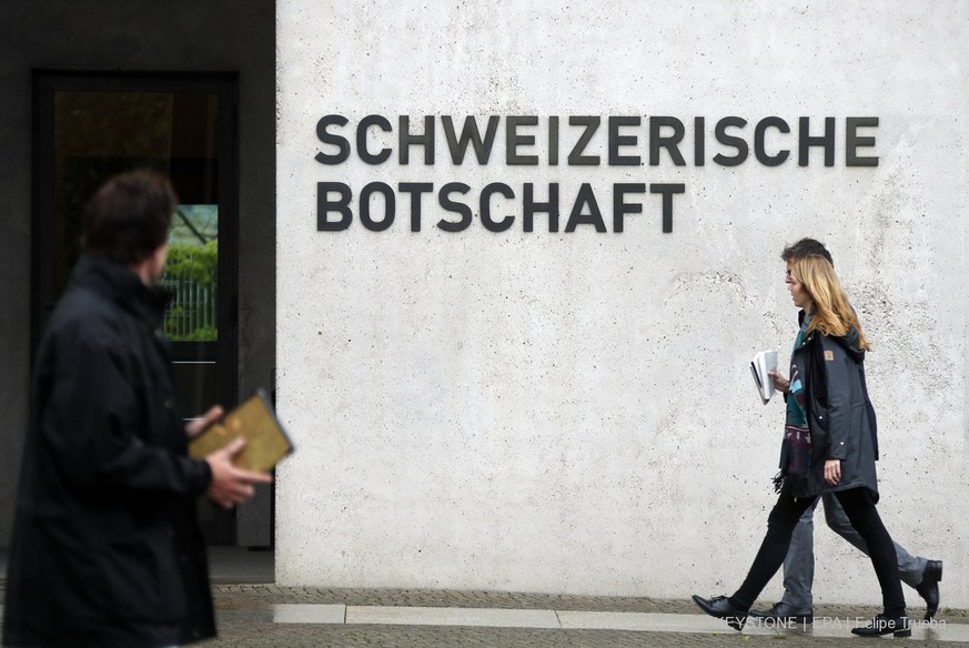 epa05943501 People walk past the entrance of the Swiss Embassy, in Berlin, Germany, 04 May 2017. The German Government called in the Swiss ambassador for a meeting after the detention of suspected spy ...