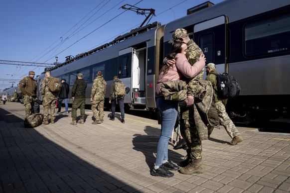 A Ukrainian soldier hugs his lover at the train station in Kramatorsk, Ukraine, Thursday, March 23, 2023. (AP Photo/Evgeniy Maloletka)
