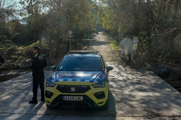 epa12562130 A police car blocks the entrance to the Natural Parc of Collserola in Barcelona, Spain, due to the presence of swine fever in the local wild boars in the area, 01 December 2025. More than  ...