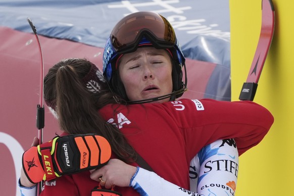 United States' Breezy Johnson, left, hugs teammate United States' Mikaela Shiffrin at the finish area of a slalom run of a women's team combined event, at the Alpine Ski World Champions ...