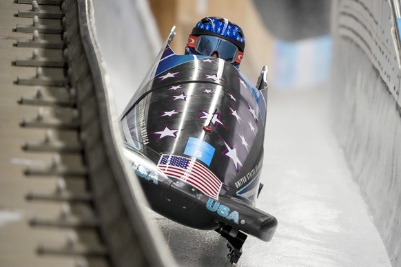 Kaillie Humphries, of United States, drives during the women&#039;s monobob heat 1 at the 2022 Winter Olympics, Sunday, Feb. 13, 2022, in the Yanqing district of Beijing. (AP Photo/Dmitri Lovetsky)