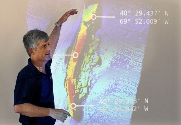 FILE - OceanGate CEO and co-founder Stockton Rush speaks in front of a projected image of the wreckage of the ocean liner SS Andrea Doria during a presentation on their findings after an undersea expl ...