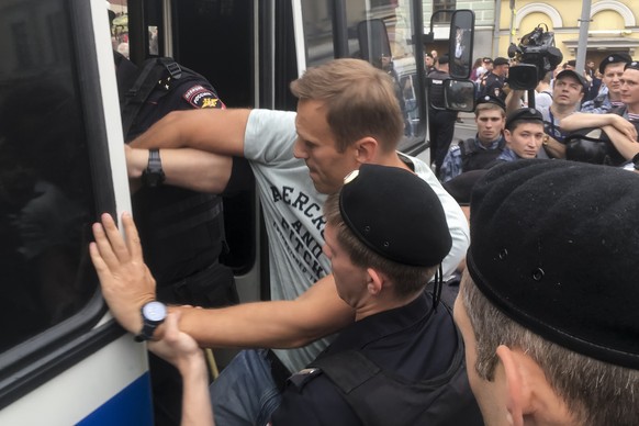 Russian police detain opposition leader Alexei Navalny, center, during a march in Moscow, Russia, Wednesday, June 12, 2019. Police and hundreds of demonstrators are facing off in central Moscow at an  ...