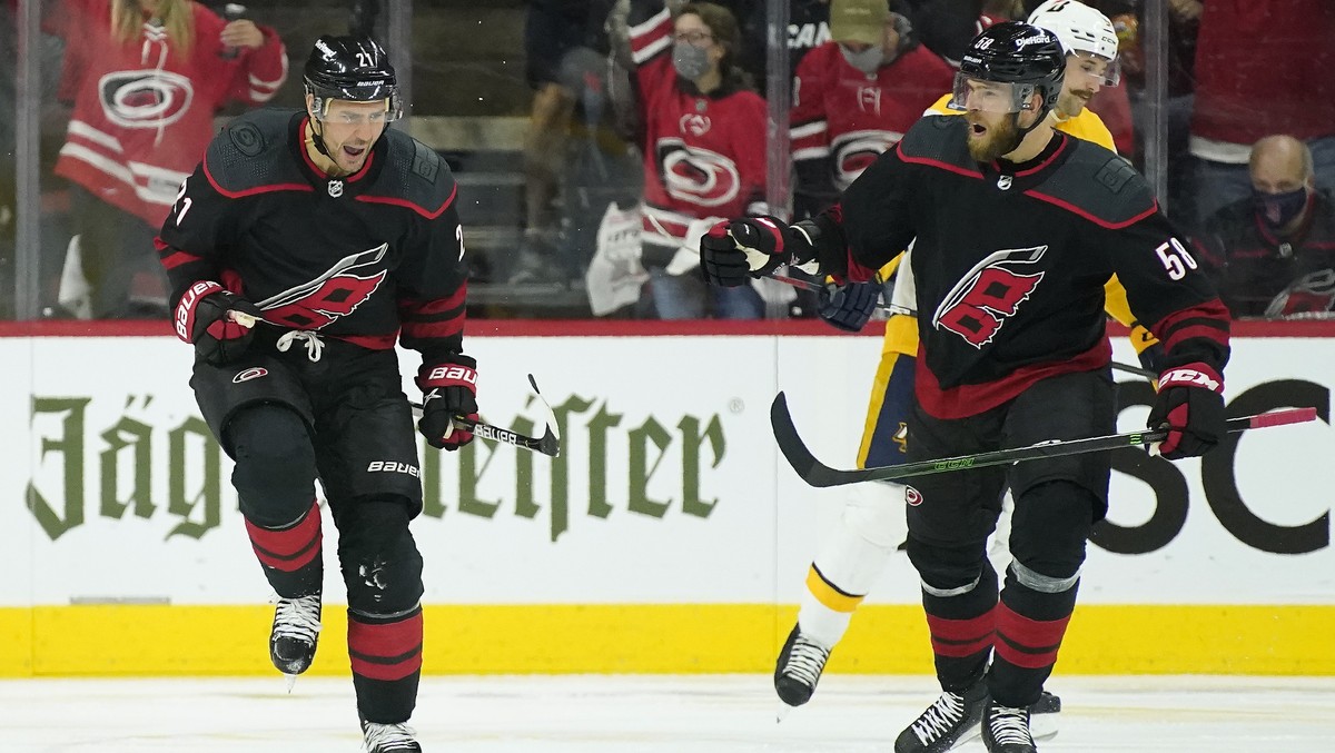 Carolina Hurricanes right wing Nino Niederreiter (21) and defenseman Jani Hakanpaa (58) celebrate Niederreiter's goal against the Nashville Predators during the third period in Game 1 of an NHL h ...