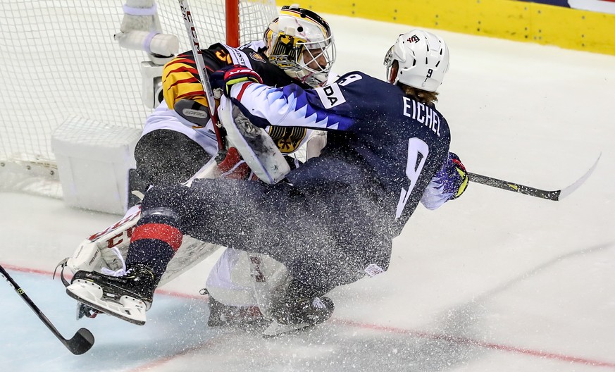 epa07584735 Jack Eichel of US (R) in action against goalkeeper Matthias Niederberger of Germany (L) during the IIHF World Championship group A ice hockey match between Germany and USA at the Steel Are ...