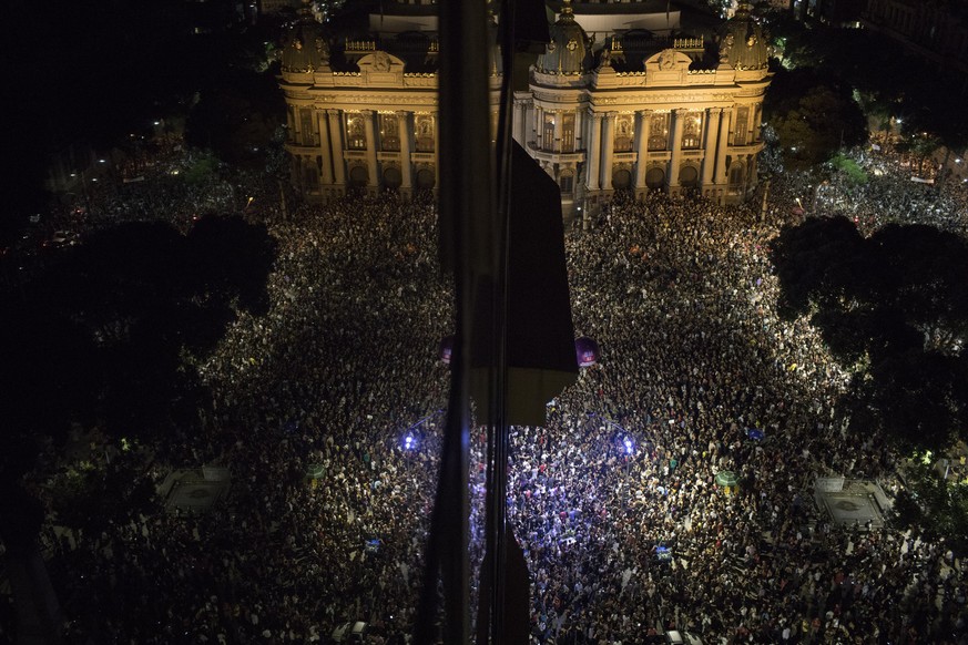 Thousands gather in front the Municipal Theater in downtown Rio de Janeiro, during a protest against the death of councilwoman Marielle Franco, who was gunned down the night before by two unidentified ...