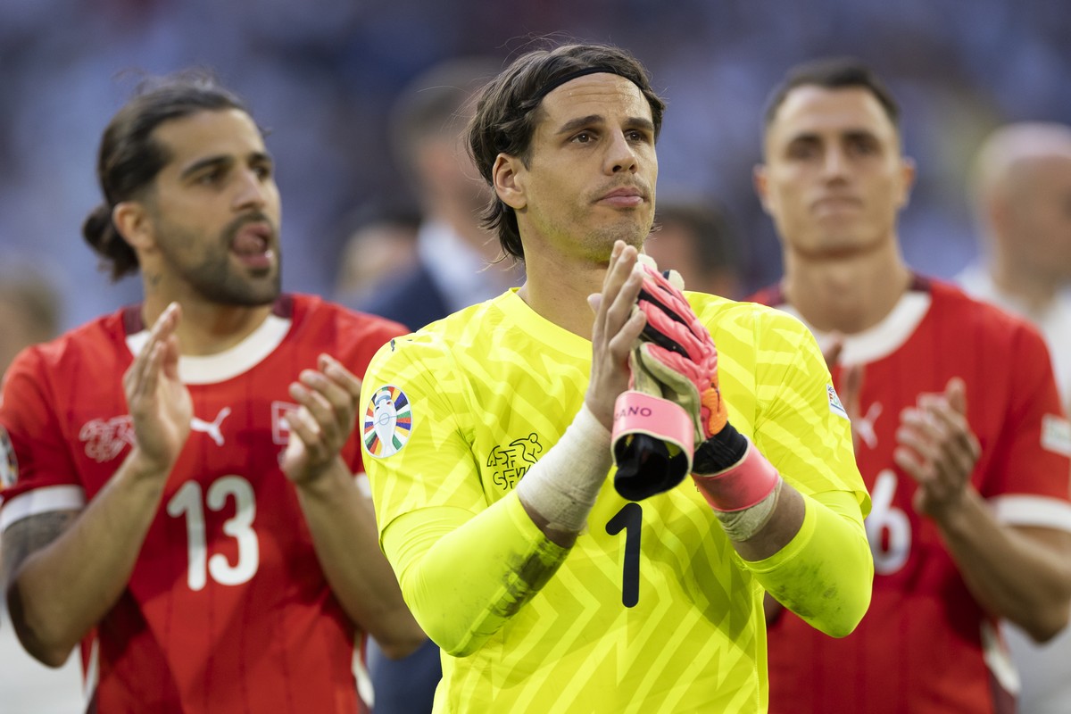 Switzerland's Yann Sommer, front, Ricardo Rodriguez, left, and Vincent Sierro are disappointed after losing the penalty shoot-out of the quarter final match between England and Switzerland at the ...