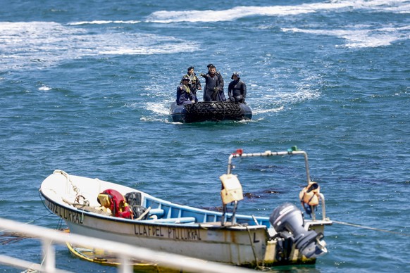 Chilean Navy search for the sunken tourist boat Rio Cholhuaco in the Negro River in Osorno, Chile, Monday, Jan. 27, 2025. (AP Photo/Emilio Torres)