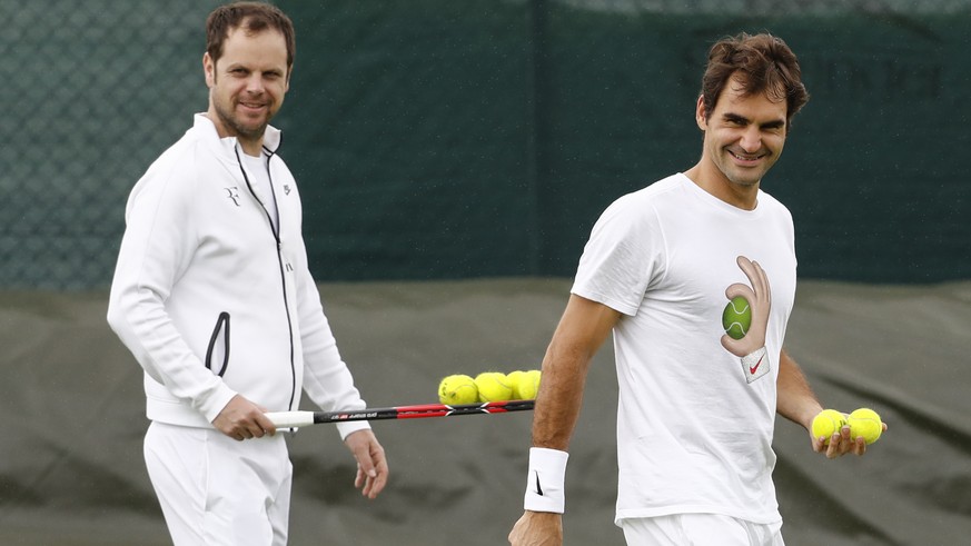 Roger Federer of Switzerland and his coach Severin Luethi react during a training session at the All England Lawn Tennis Championships in Wimbledon, London, Thursday, June 23, 2016. The Wimbledon Tenn ...