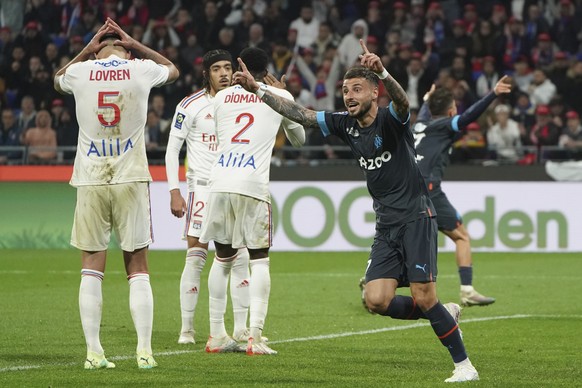 Marseille&#039;s Jonathan Clauss celebrate after Lyon&#039;s Malo Gusto scored an own goal during the French League One soccer match between Lyon and Marseille at the Groupama stadium, in Decines, nea ...