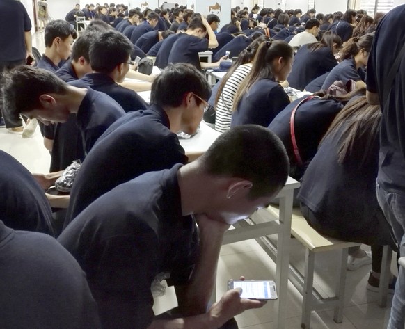 In this July 12, 2016, photo, workers receive job training at Apple supplier Jabil Inc.&#039;s Green Point factory in Wuxi in eastern China&#039;s Jiangsu Province. Apple Inc. and Ivanka Trump&#039;s  ...