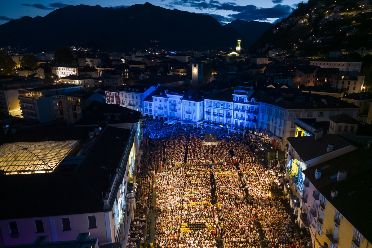 A general view shows spectators waiting for the start of a film screening on the Piazza Grande square during the 76th Locarno International Film Festival in Locarno, Switzerland, Saturday, August 5, 2 ...